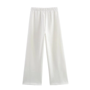Detail of white wide-leg trousers showing the elastic high waist and draped fabric texture