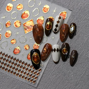 Amber tones nail stickers with gold foil and geometric patterns for manicure