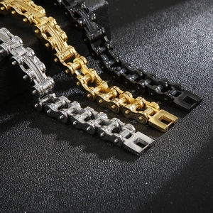 Detail view of motorcycle chain bracelets in silver, gold, and black stainless steel