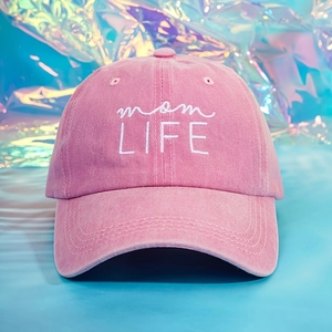 Close-up of pink washed cotton baseball cap with white mom LIFE embroidery detail