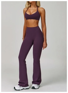 Detail of purple high-waist flared yoga pants and halter neck sports bra set texture