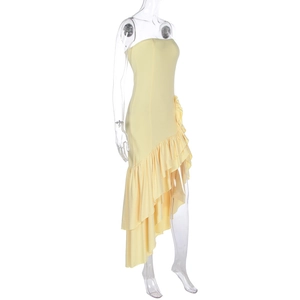 Detail of light yellow strapless dress with tiered asymmetrical ruffled hem design