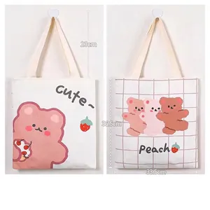 Cute canvas tote bag for students featuring double-sided pink cartoon bear strawberry print