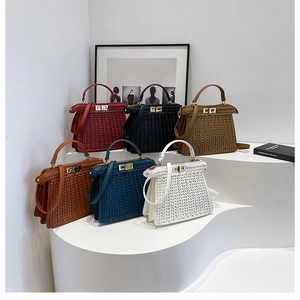 Close-up of woven texture handbags in multiple colors with metallic twist lock hardware