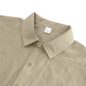 Detail shot of khaki linen shirt collar showing 95% linen material and size XL tag