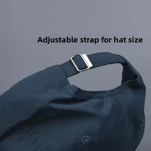 Detail of adjustable metal buckle on dark blue lightweight nylon baseball cap