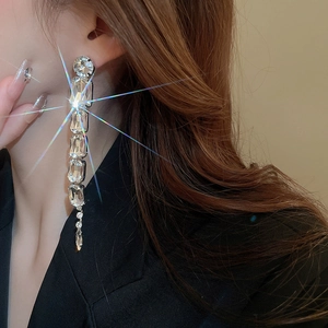 Close-up of silver tassel earrings with square crystals on model for a sparkling look