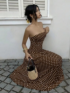 Detail of elegant brown polka dot off-shoulder dress with a chic waist slimming design