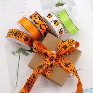 Detailed view of Halloween ribbons with spider web and pumpkin patterns for DIY gift wrapping