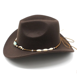 Detail of dark brown felt cowboy hat featuring turquoise beads and leather trim accents