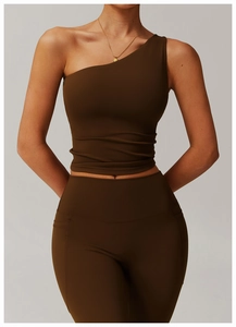 Detail of dark brown one-shoulder yoga top and high-waisted leggings with side pocket