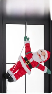 Detail of Santa Claus figure climbing a white rope for festive window decoration