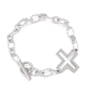 Silver retro bracelet with OT buckle and rhinestone-set X pendant on white background