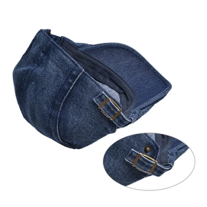 Detail of adjustable bronze buckle and stitching on dark blue denim beret cap