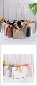 Detail of premium paper gift bags with elegant ribbon bows in assorted colors