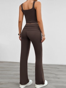 Rear view of women's dark brown sleeveless top and high-waisted pleated flare trousers set