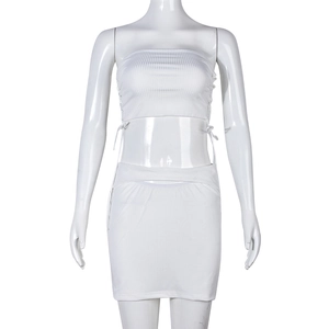 Detail of white ribbed knit two-piece set featuring side drawstring ties on the tube top