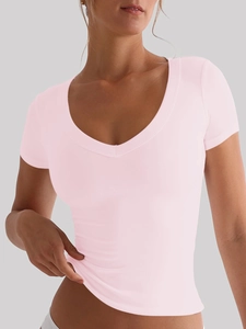 Detail view of pink slim fit short sleeve V-neck top with professional fabric texture
