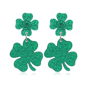 Sparkling green glitter four leaf clover earrings on a white background with reflections
