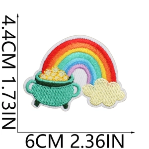 Detailed embroidery of a St. Patrick's Day rainbow pot with gold coins and clear stitching