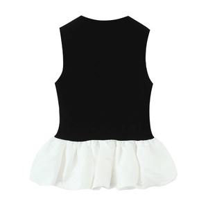 Sleeveless black and white patchwork ruffles top shown flat on a white background