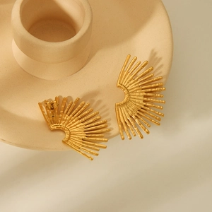 Fashionable 18K gold plated stainless steel fan-shaped earrings on a beige tray