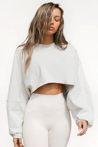 Short light gray crew neck cropped sweatshirt with high waisted white yoga pants
