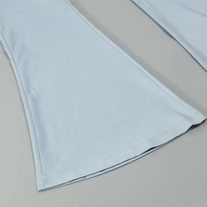 Detailed close-up of stitching and smooth fabric on light blue wide leg jumpsuit hem