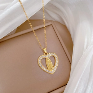 Luxury gold heart pendant necklace with saint portrait relief and crystal frame on satin