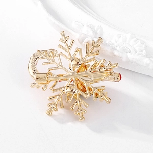 Golden enamel Christmas snowflake and candy cane brooch pin for festive accessories