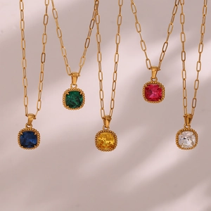 Detail of five square gemstone pendants in diverse colors on golden paperclip chains