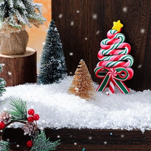 Christmas tree shaped lollipops with red green white spiral texture in snowy scene
