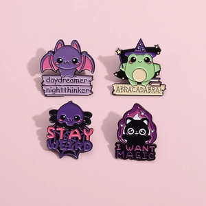 Set of four cartoon magic animal enamel pins featuring a bat, frog, black cat, and monster