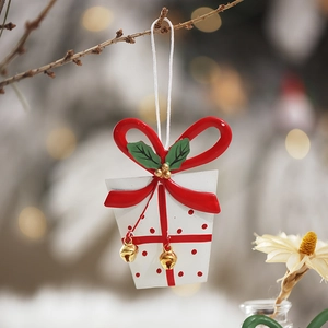 Christmas white gift box ornament with red polka dots, bow, and golden bells