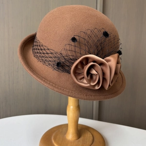 Elegant brown wool cloche hat with vintage mesh veil and satin flower decoration