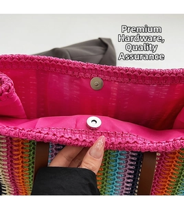 Close-up of pink inner lining and metal magnetic buckle on colorful woven tote bag