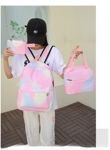 Three-piece school bag set with pink and blue gradient tie-dye pattern on model