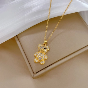 Luxurious gold bear pendant necklace with full crystal pavé on a silk jewelry setting