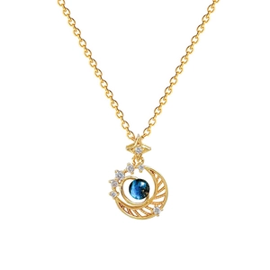 Star and moon gold pendant necklace with blue gemstone and diamonds on white background