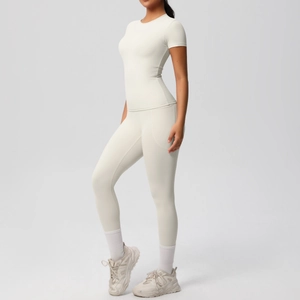 Detail view of cream white yoga set featuring side pocket leggings and slim fit t-shirt
