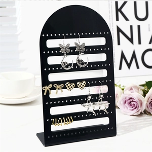 L-shaped acrylic jewelry stand with 126 holes displaying various elegant earrings