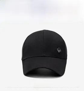 Detail view of the black baseball cap showing the metallic fashion logo on cotton fabric