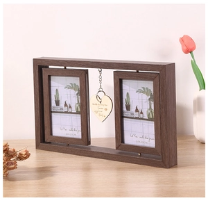 Rotating 6-inch brown wood picture frame featuring a hanging heart charm with engraving