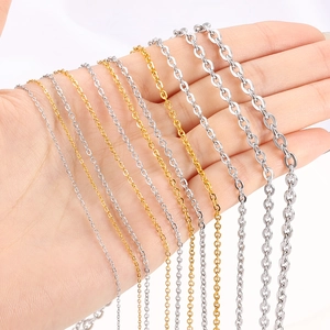 Flat O-cross chains in gold and silver variety shown in multiple sizes on hand