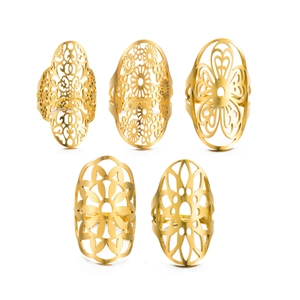 Close-up of five gold vintage stainless steel rings with hollow geometric patterns