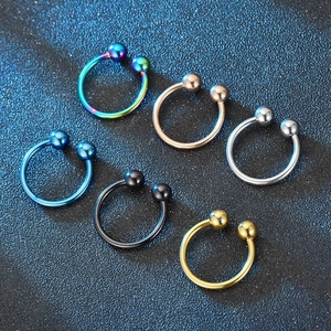 Set of six colorful titanium horseshoe rings in various metallic finishes and smooth textures