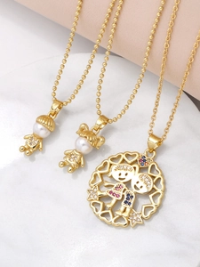 Detailed view of gold necklaces with pearl boy and girl charms and zircon heart pendant