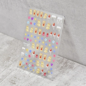 Close-up of cute 5D nail art stickers with bear, heart, and strawberry patterns