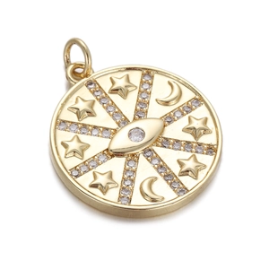 Detailed view of a gold compass pendant with engraved star, moon and zircon eye motif