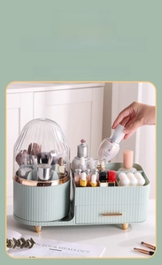Close-up of a green cosmetic organizer with a rotating brush holder and golden legs